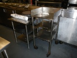 (2) STAINLESS STEEL TABLES  ONE WITH ROLLERS AND BEVERAGE TRAYS INCLUDED