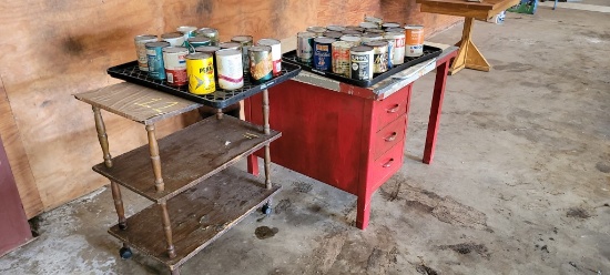 LOT OF OLD OIL CANS(SOME STILL FULL) W/ DESK AND CART