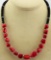 CORAL AND BLACK BEADS