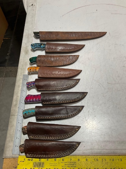 UNUSED (9) HANDMADE DAMASCUS KNIVES IN MOLD PROOF LEATHER SHEATHS, ASSORTED SIZES AND COLORS, STEEL
