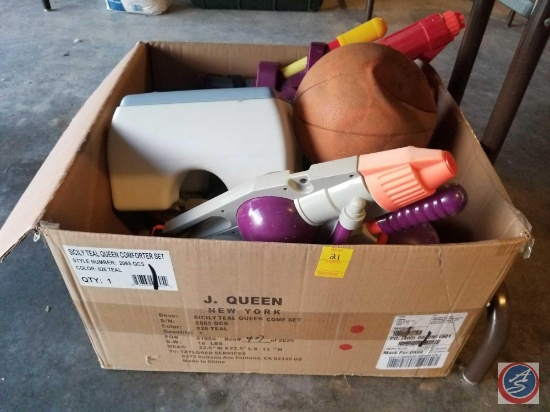 Large box containing children's outdoor toys including water guns, basketball, etc