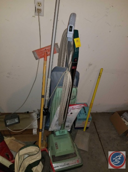 (2) vintage vacuum cleaners, and assorted long handled household cleaning tools