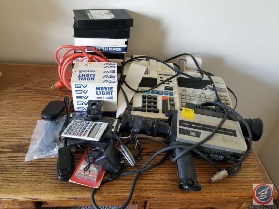 Vintage electronics and VHS tapes, including a Hitachi video camera, and calculators/printers