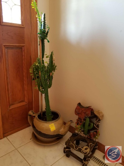 Live cactus in pottery tea pot planter, with decorative ceramic decorative chair