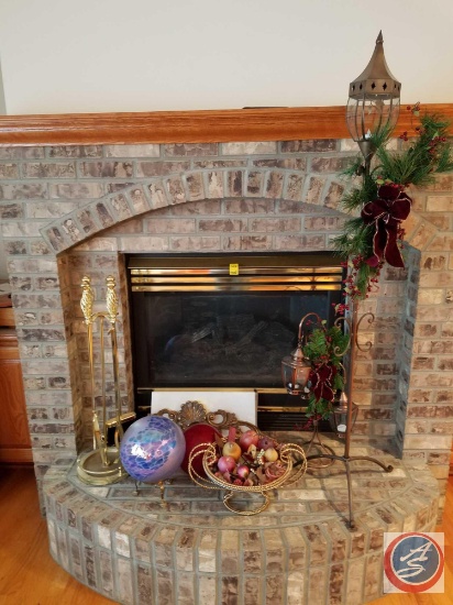 Items sitting on fireplace to include; 4 piece fireplace tool set, metal basket with plastic fruit,
