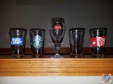 (2) Rebel IPA, (2) Empyreal Brewing, (1) Bud Light, (1) Woodchuck pint glasses, and (1) Stella
