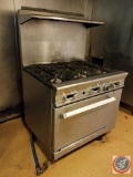 Stainless steel, commercial 6 burner with oven gas range (make and model unavailable)