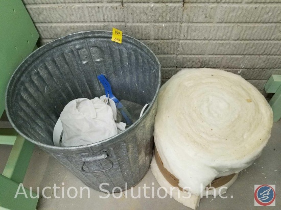 Metal trash can and roll of new insulation