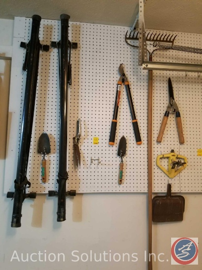 contents of pegboard to include loppers, hand shovels, sprinkler, rake and more (pegboard not