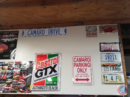 All signage in garage, including posters, metal signs, Stop sign, and more