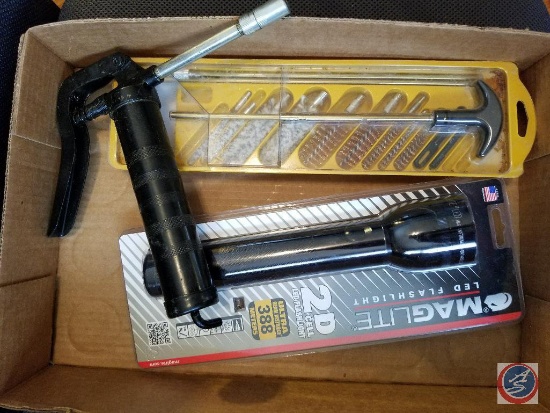 Flat containing gun cleaning kit, grease gun, and Maglite flashlight