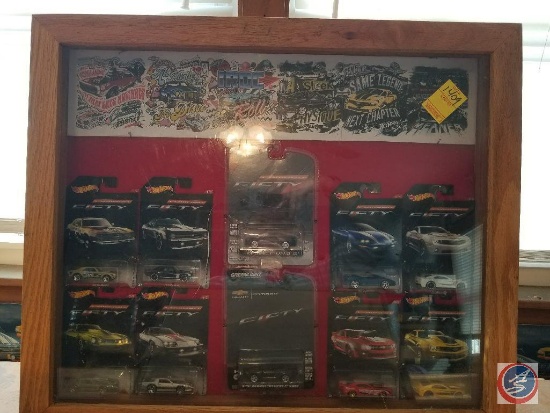 Large shadow box containing Hot Wheel Camaro collectibles in blister packs