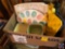 Box containing Easter themed dish ware including ice cube trays, deviled egg serving dish, bowls,