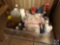 Tote containing Pine Sol, napkins, and assorted cleaning supplies