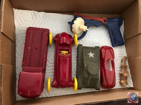 A selection of vintage plastic cars, a wooden tank and a top