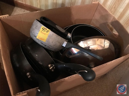 Box containing sauce pans, skillets, and assorted lids