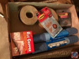 Flat containing shelf grippers, packing tape, pot magnet, and more