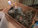 Box containing plastic palm tree design cups, wine glasses, plates, and more