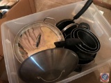Tote containing stock pot with lid, sauce pans, and some lids