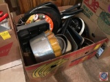 Box containing a variety of cake pans, skillets, and more