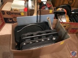 Large box containing muffin tins, cutting board, metal baking pans and sheets, etc