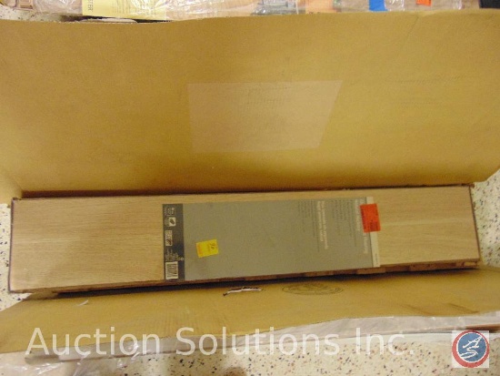 Box of Glueless laminate flooring, natural hickory. (9) pieces in box, each plank measuring