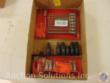 Flat containing 7-piece long handled hex bit socket set, Husky 8 piece tamper proof bit set, and