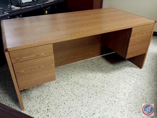 Light brown desk w/ [4] drawers measuring 6ftx3ftx2.5ft