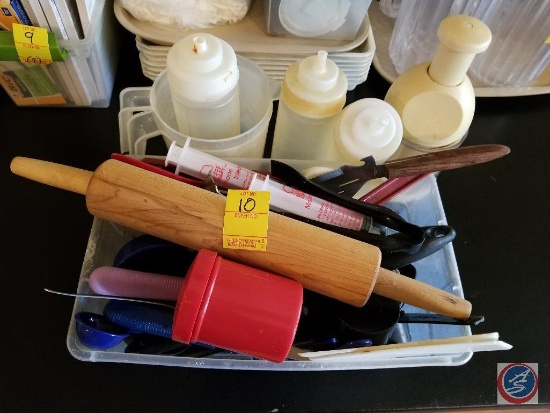 Tote containing cooking utensils, condiment dispensers, and (2) plastic measuring cups