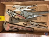 assorted vise grips and pipe wrenches