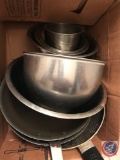 box of assorted frying pans and mixing bowls