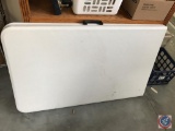 White plastic folding table with handle