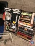 Assorted Hard cover and paper books, vcr tapes, and workout equipment