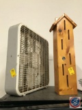 Tall birdhouse and a box fan