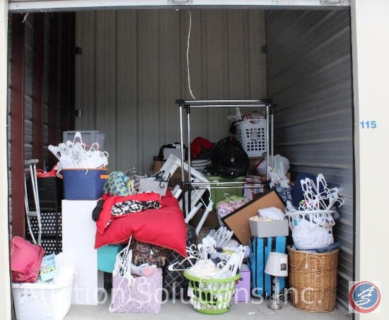 10x10 unit containing luggage, hangers, clothing rack, dog bed, baskets, ladies clothing, plastic