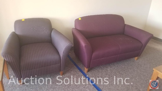 Maroon love seat and a purple and black striped chair