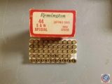 Box of assorted brass and live ammo and Pachmayr pistol grip 44 special