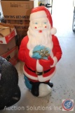 Santa Claus and Turkey Yard Decorations; an American Flag; and Holiday Lights