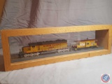 Union Pacific model train #8012 and Union Pacific model train #25842 in glass and wooden display