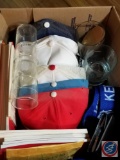 Box containing Union Pacific baseball caps, Union Pacific Glassware, Union Pacific badges, and an