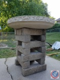 Round cement bird bath on cement blocks
