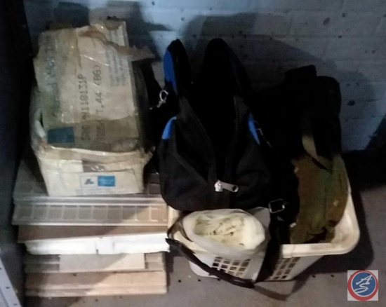Stack of assorted tile, basket, plastic sheeting, gym bag and more
