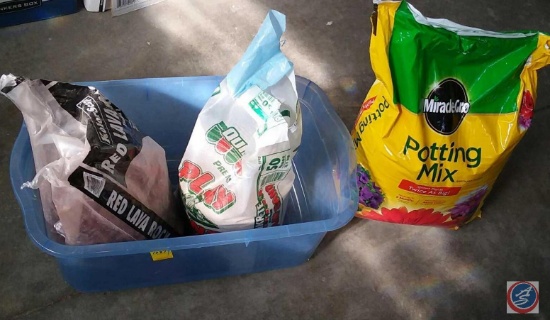 Tote containing opened bag of red lava rock, opened bag of sand, new bag of Miracle-Gro potting mix