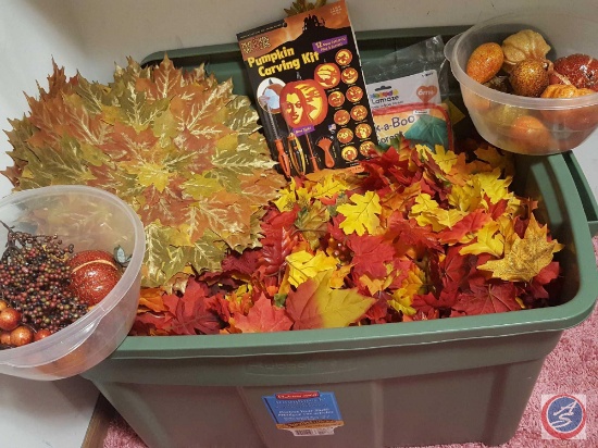 Large bin containing silk leaves, pumpkin carving kit and assorted Fall decorations