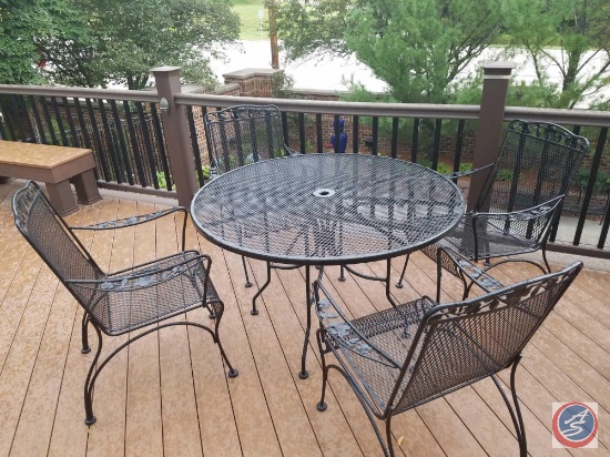 6 pc. Wrought iron patio set: round table and (4) chairs, and an umbrella stand