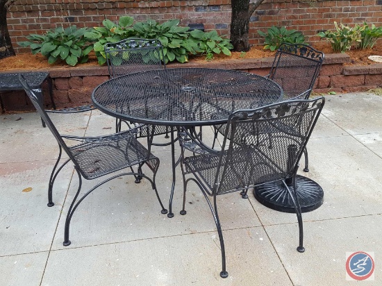 7 pc. Wrought iron patio set: round table and (4) chairs, green umbrella and stand