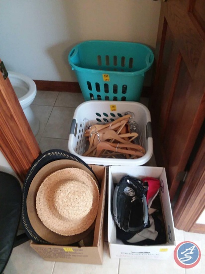 Plastic laundry hamper and laundry basket containing assorted wood and plastic hangers, box