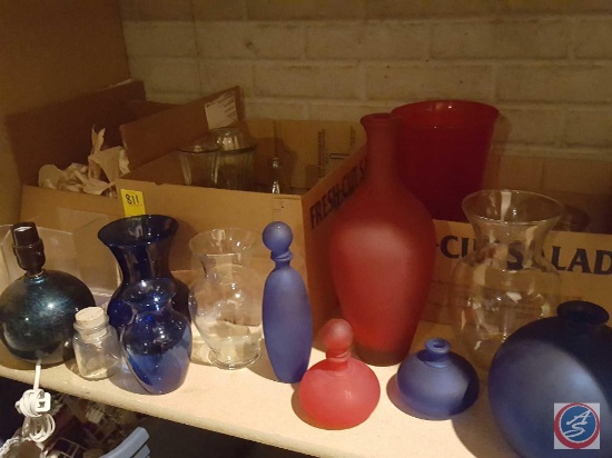 A variety of Blue and Red glass vases, candle holders, a small table lamp (no shade) and more