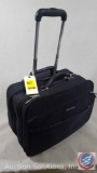 Medum Canvas Samsonite Rolling Brief Case. Includes some small target stickers.
