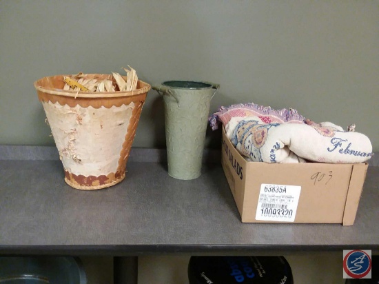 Waste basket containing decorative Indian corn, tin flower vase, Cherished Teddies blanket, knitted